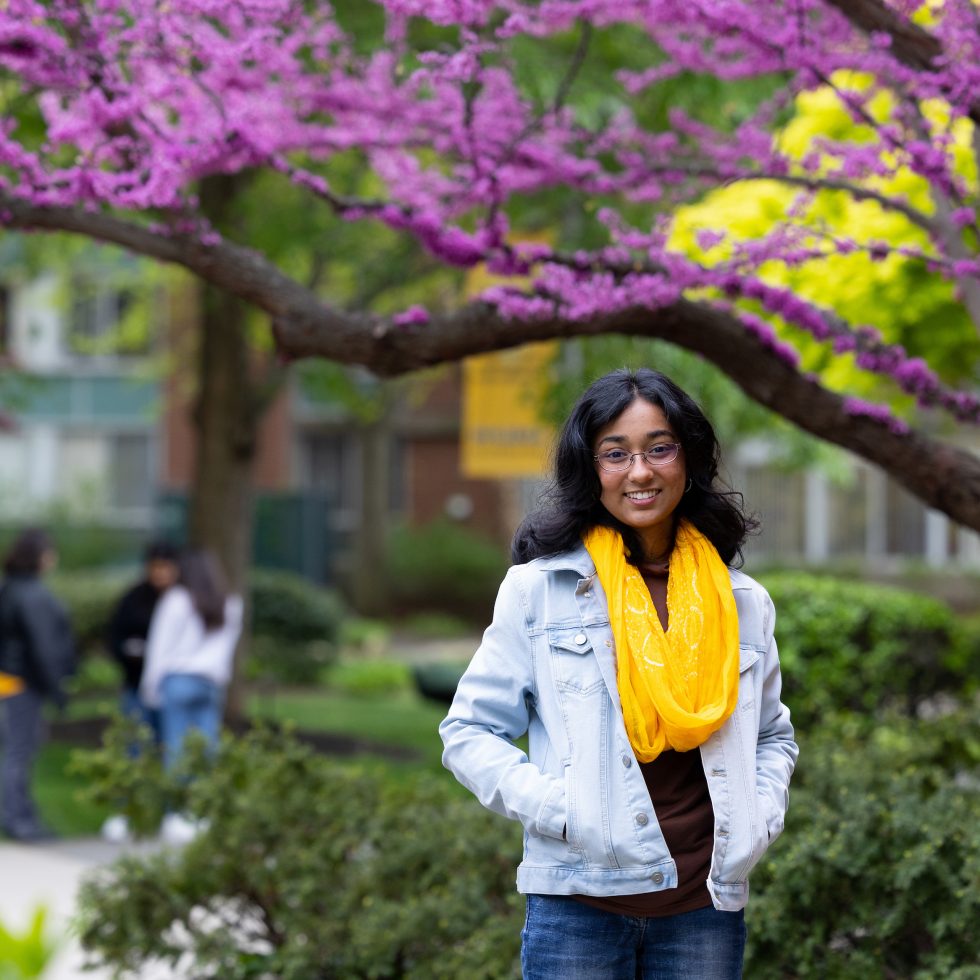 An  student looking at the camera on campus.