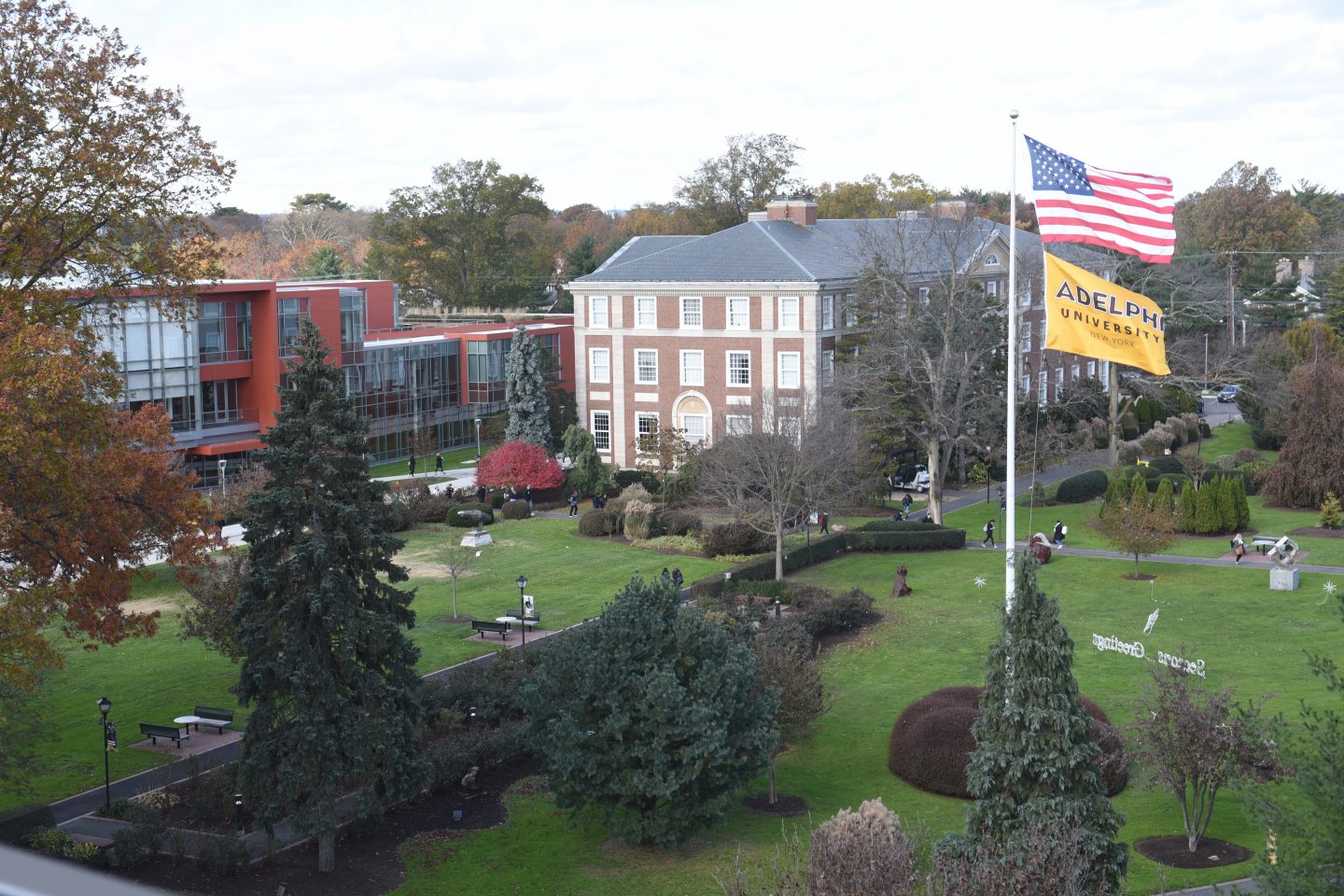 Aerial view of , Garden City campus - Showing Nexus Building, Levermore Hall and the Flagpole lawn with both American and flags waving.